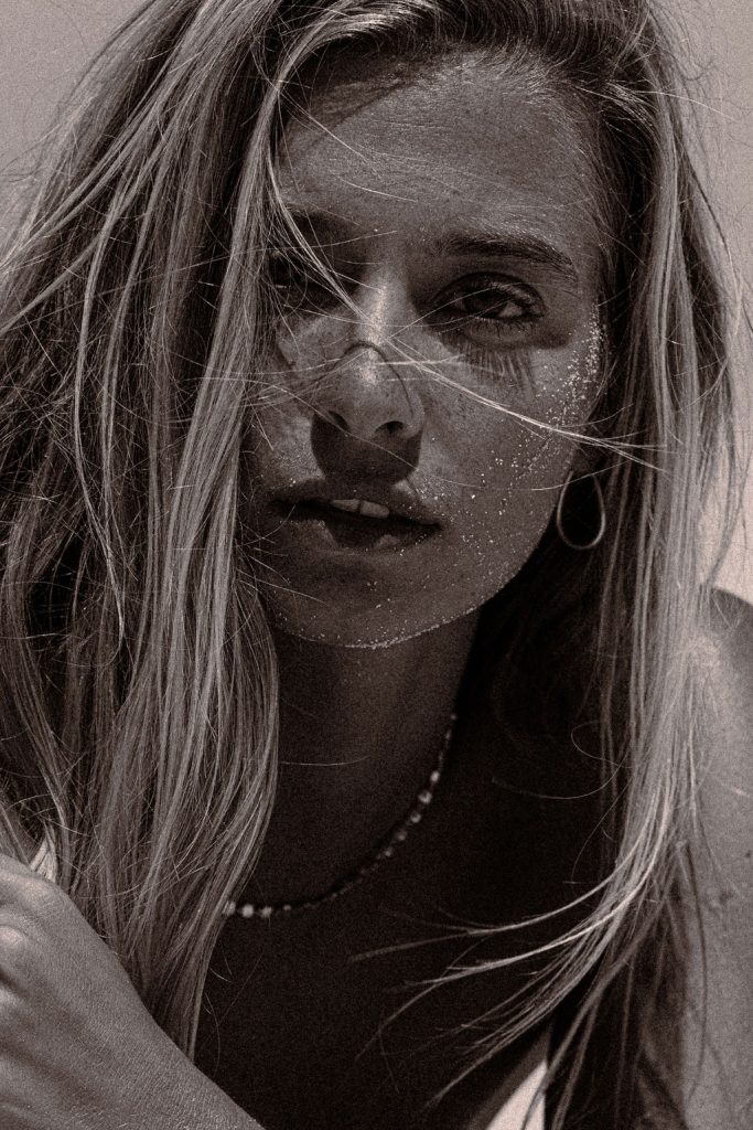 Confident, radiant woman gazing with intensity, symbolizing personal transformation and self-belief