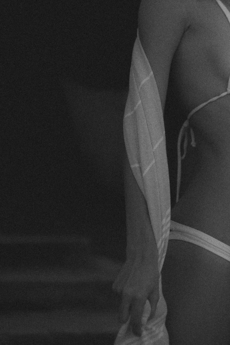 Black and white side profile of a confident woman in a bikini symbolizing empowerment and self-confidence.