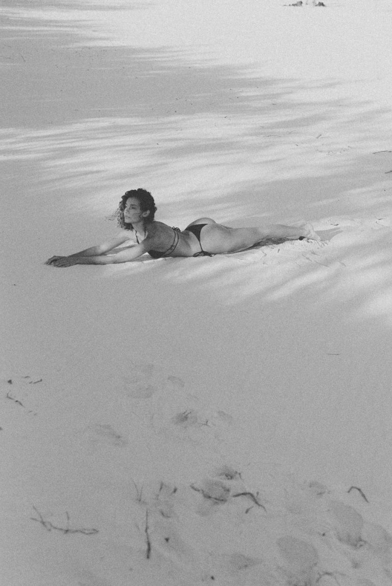 Confident woman lying on the beach embracing empowerment and transformation