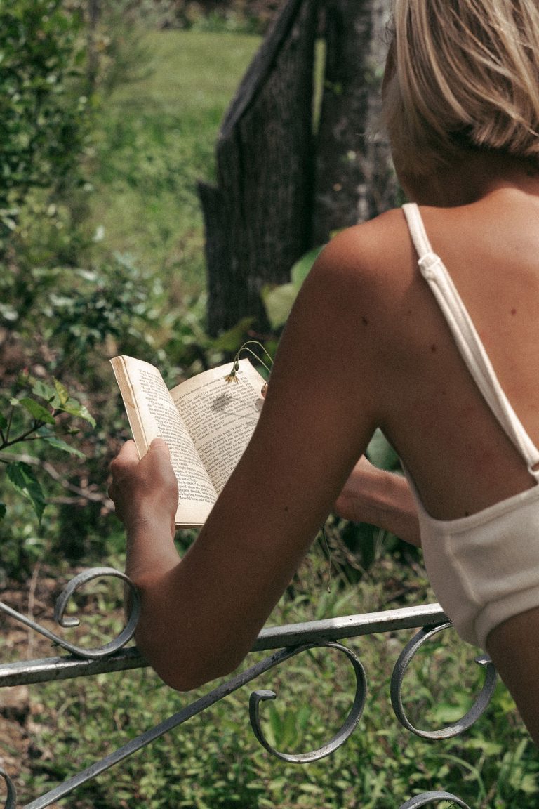 Woman reading 2026 self improvement books with neuroplasticity brain imagery representing identity transformation and subconscious reprogramming for dream life manifestation