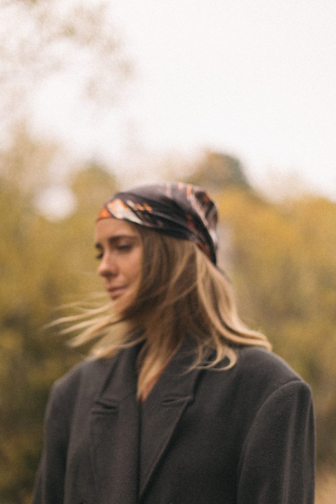 Woman creating 2026 vision board with photos representing her transformed identity and dream life goals