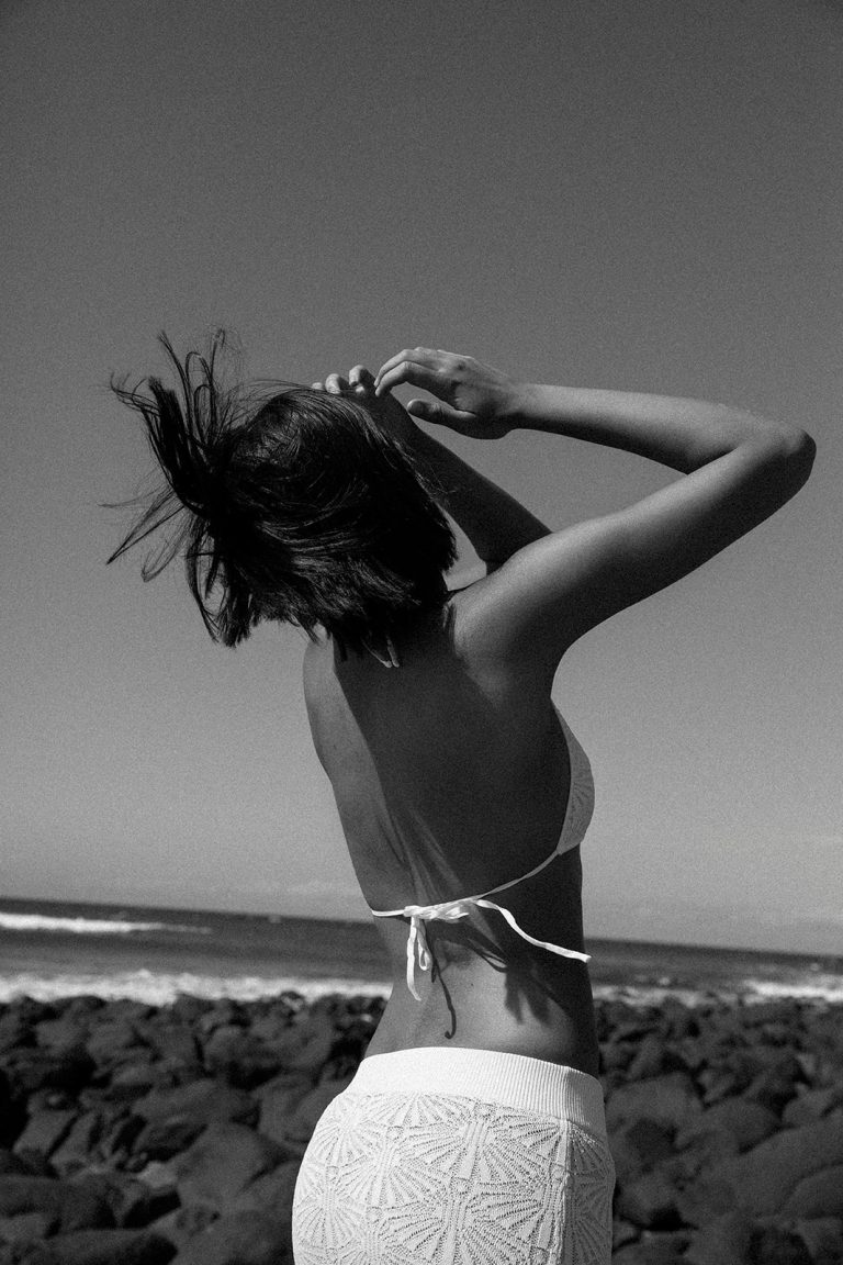 Woman writing 2026 goals in journal with confident smile representing lucky girl syndrome and identity transformation for goal achievement