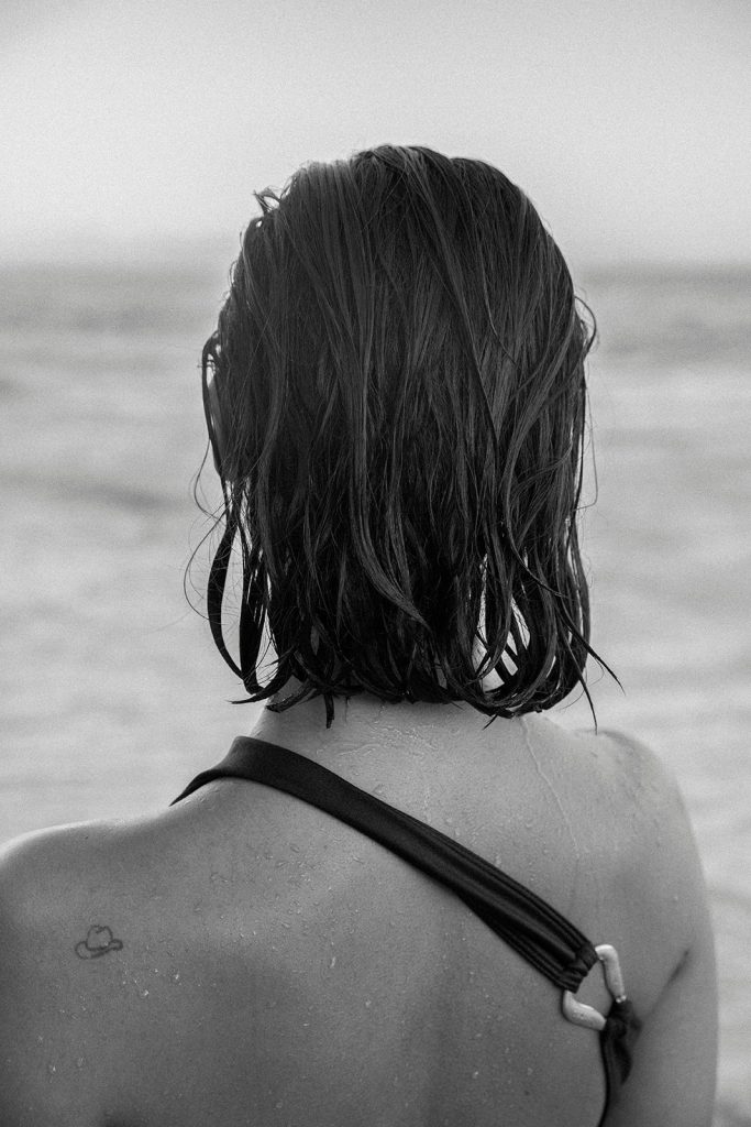 Confident woman writing 2026 goals with main character energy mindset transformation journal